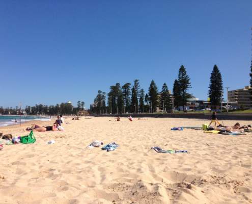 People sunbathing on Queenscliff Beach